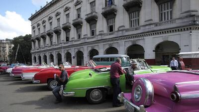 Drivers stand near their vintage cars waiting for clients in Havana. Reuters