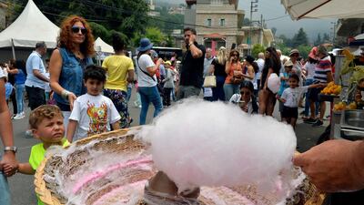 A vendor makes cotton candy for a customer during Cherry Day in the village of Hammana, southeast of Beirut, Lebanon. EPA