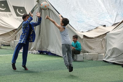 Children play as people who fled their homes in southern Lebanon after Israeli displacement orders shelter on a football pitch in Sidon on Wednesday. Reuters