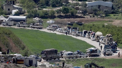 Vehicles carry refugees back to their homes, as some are afraid of the coronavirus outbreak in crowded camps in Dayr Ballut, Syria. Reuters