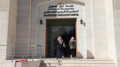 Employees enter the defunct Palestinian Parliament building in the West Bank city of Ramallah. AFP