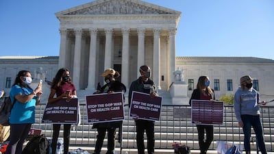 Demonstrators hold signs in front of the US Supreme Court in Washington, as the high court opened arguments in the long-brewing case over Affordable Care Act. AFP