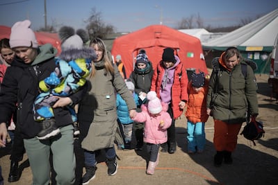Refugees fleeing Ukraine are receiving aid from the International Red Cross and other charitable organisations at the Vysne Nemecke border. Getty Images