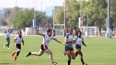 Josie Simm of Abu Dhabi Bats chases a Dubai Hurricanes player.