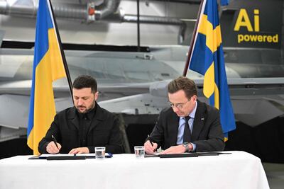Swedish Prime Minister Ulf Kristersson, right, and Ukrainian President Volodymyr Zelenskyy sign a letter of intent for Gripen jets. AFP