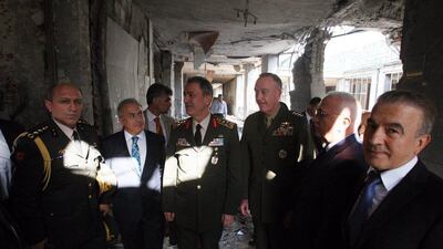 Turkey's chief of staff General Hulusi Akar (C) and US chairman of the joint chiefs of staff General Joseph Dunford (third from R), visit a destroyed part of the Turkish parliament in Ankara on August 1, 2016. EPA