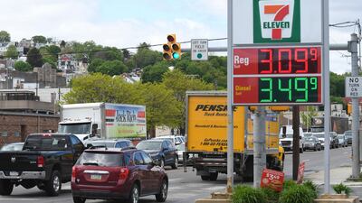 Traffic moves along Pennsylvania Route 61 as gas prices are seen on the sign at a Sunoco gas station. A cyberattack on a critical US pipeline is sending ripple effects across the economy, highlighting cybersecurity vulnerabilities in the nation's aging energy infrastructure. The average gasoline price jumped six cents to $2.96 over the past week, and it’s expected to continue climbing because of the pipeline closure, according to AAA. AP Photo