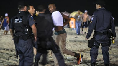 A man is apprehended by police while watching the semi-final match between Brazil and Germany in Rio de Janeiro. AFP