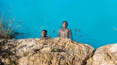 Palestinian children cool down in a pool in the village of Bilin, west of Ramallah, in the occupied West Bank. AFP