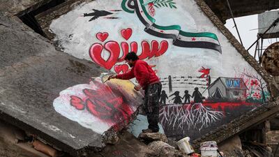 The mural shows a dove holding an olive branch in its beak flying over a Syrian opposition flag in the shape of the Arabic numeral 9, with the word 'years' below. AFP