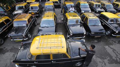 A man washes a Premier Padmini taxi at a taxi parking area in central Mumbai. The Premier Padmini was manufactured in India by Premier Automobiles from 1964 to 2000 and is based on the design of Fiat’s 1100-series cars from the 1960s. The vehicle quickly became the iconic workhorse in Mumbai’s fleet of black and yellow taxis until economic liberalisation in the 1990s allowed different makes and models to be produced in India. With a government order banning taxis over 25 years old, the number of Premier Padmini taxis has begun to dwindle and, in a few years, they will be gone from Mumbai’s streets altogether. Local media estimates put Mumbai’s current taxi fleet at about 51,000 vehicles, of which it is estimated that about 8,000 vehicles are over 25 years old. Vivek Prakash / Reuters