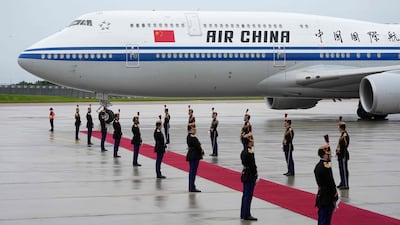 Members of France's Republican Guard form an honour guard for the arrival of Mr Xi and Ms Peng at Orly airport, south of Paris, on Sunday. AFP