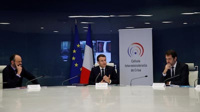 French President Emmanuel Macron, centre, and government ministers attend a meeting at the emergency crisis centre of the Interior Ministry in Paris on March 20, 2020 to discuss the coronavirus pandemic. EPA