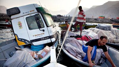 Iranian and Afghan traders load up boats with merchandise destined for Iran in Mina Irani in Khasab, a small port town in Musandam , Sultanate of Oman. Silvia Razgova / The National
