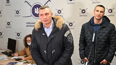 Kyiv mayor Vitali Klitschko, left, and his brother and fellow former heavyweight boxing champion Wladimir, during a visit to a volunteers' recruitment centre in Kyiv on February 2. AFP