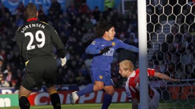 Manchester United's Carlos Tevez, centre, scores the only goal of the game at Stoke.