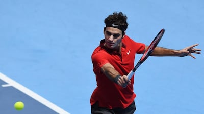 Roger Federer plays a return to Kei Nishikori during their ATP World Tour tennis match at the O2 arena in London on Tuesday, Nov. 11, 2014. (AP Photo/Tim Ireland)