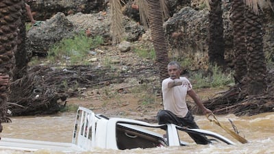 A man gestures as he tries to save a vehicle swept away by flood waters on Yemen’s Socotra island on November 2, 2015. Reuters