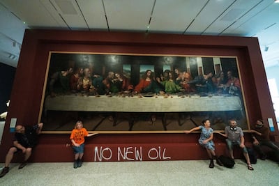 Five Just Stop Oil activists spray-paint the wall and glue themselves to the frame of the painting 'The Last Supper' at Royal Academy, London. Getty Images