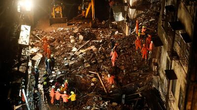 National Disaster Response Force and fire brigade personnel look for survivors trapped in the debris after part of a residential building collapsed in Mumbai, India on July 16, 2020, killing six people. Reuters