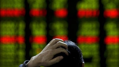 A man checks stock prices at a brokerage house in Beijing. China’s CSI300 index gained 1.68 per cent after the Golden Week holidays. AP