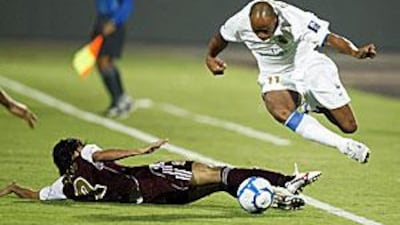 Denilson, scorer of Bunyodkor's opener, hurdles an Al Wahda tackle last night.
