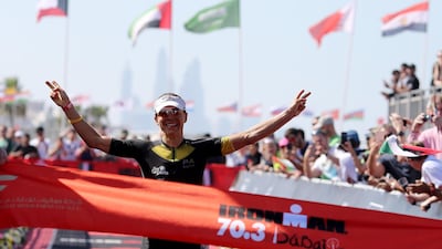 Anne Haug of Germany celebrates winning the women's race Ironman 70.3 Dubai. Nigel Roddis / Getty Image