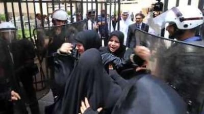 A female relative of one of the protesters taunts police yesterday as she leaves the courthouse.