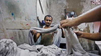 Workers dye fabrics inside a dye factory at an industrial area in Mumbai, India. Textile exports may be at risk amid US-India duties wrangle. Reuters