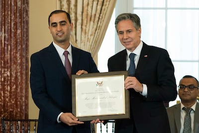 US Secretary of State Antony Blinken presents the 2022 Trafficking in Persons Hero Award to Major Mohammad Al-Khlaifat, of Jordan, during the 2022 Trafficking in Persons (TIP) Report launch ceremony at the State Department in Washington, DC, on July 19, 2022. (Photo by Manuel Balce Ceneta / POOL / AFP)
