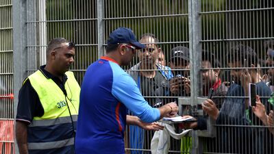 Indian team coach Rahul Dravid signs autographs for fans after at Edgbaston. AP