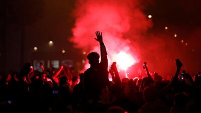 PSG supporters gather on the Champs-Elysees. AP