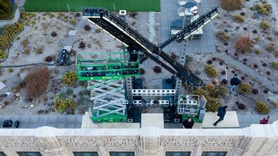 Workers install lighting to an "X" sign on the headquarters of the company formerly known as Twitter, in San Francisco, US. AP