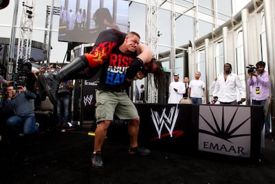 John Cena hoists up Kane during a press conference at the Burj Khalifa in Dubai in 2012. Sarah Dea / The National