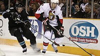 Ottawa Senators defenseman Chris Phillips, right, is chased by former teammate San Jose Sharks right wing Dany Heatley.