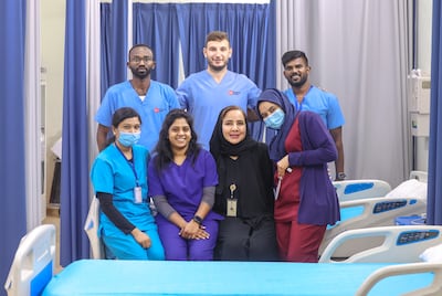 Dr Samah Obaid, front, second right, with her healthcare team at Emirates Humanitarian City. Victor Besa / The National