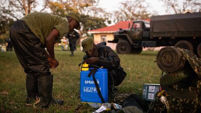 Soldiers prepare to spray crops with pesticide to counter the locust invasion in Katakwi, Uganda. Getty Images