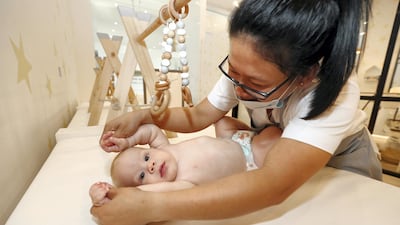 Six-month-old Arthur Cook gets a massage from Jacquelyn Pe–a at Baby Spa in Abu Dhabi. Photo: Chris Whiteoak / The National