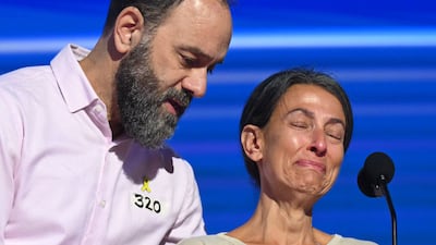 Jon Polin comforts his wife Rachel Goldberg as she speaks about their son Hersh Goldberg Polin, who is being held hostage by Hamas. AFP