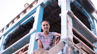 Dhow captain AbdulRedha Mohammed, 42, from Kish Island, looks down from his dhow. Reem Mohammed / The National