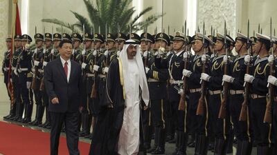 Sheikh Mohammed bin Zayed and Xi Jinping inspect a guard of honour in China in 2012. Reuters