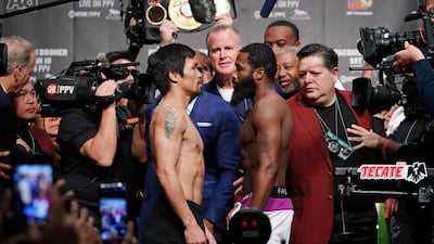 Manny Pacquiao, left, and Adrien Broner, right, during weigh-ins ahead of today's welterweight championship boxing bout. John Locher / AP