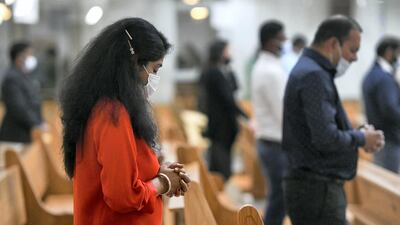 Worshippers pray during Christmas Eve midnight mass at St Paul's Catholic Church in Mussafah, Abu Dhabi. Khushnum Bhandari for The National
