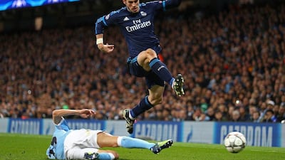 Gareth Bale of Real Madrid CF hurdles the challenge from Jesus Navas of Manchester City during the UEFA Champions League Semi Final first leg match between Manchester City FC and Real Madrid at the Etihad Stadium on April 26, 2016 in Manchester, United Kingdom. (Photo by Paul Gilham/Getty Images)