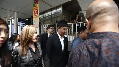 City Harvest Church pastor Kong Hee, centre, and his wife Ho Yeow Sun, left, outside the state court in Singapore, 21 October 2015. The founder of City Harvest Church, Kong Hee has been found guilty of embezzling church funds, along with five other leaders of the church. Wallace Woon/EPA