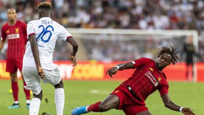 Origi slides in to win the ball for Liverpool. EPA