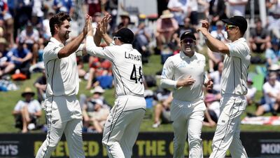 New Zealand bowler Colin de Grandhomme, left, celebrates after taking the wicket of England's Dom Sibley. AP