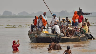 Flood-affected residents along move to a safer place by boat as the water level of the Ganges rises after heavy rains in Patna, India. AFP