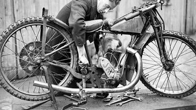 Homo cathectus: the monkey mascot of London's Crystal Palace Speedway helps a mechanic tune a motorcycle belonging to a member of the 1932 English motor racing team.