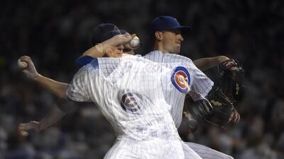 A multiple-exposure sequence of Kyle Hendricks pitching for the Chicago Cubs. David Banks / Getty Images / AFP